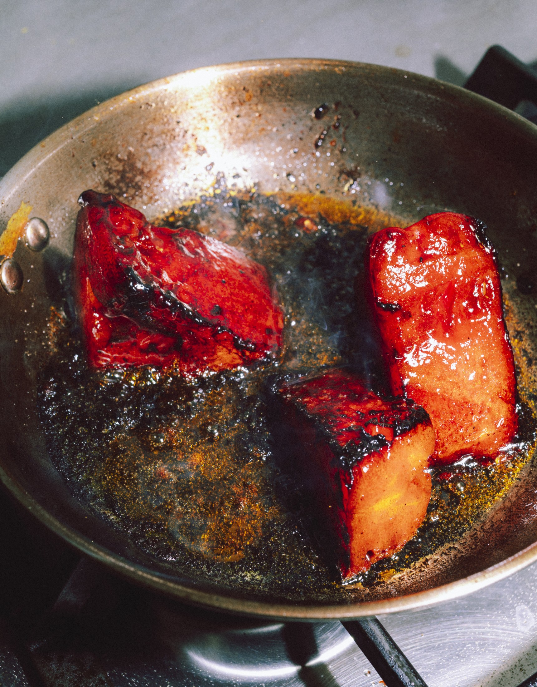 Overhead shot of fish searing in a hot pan
