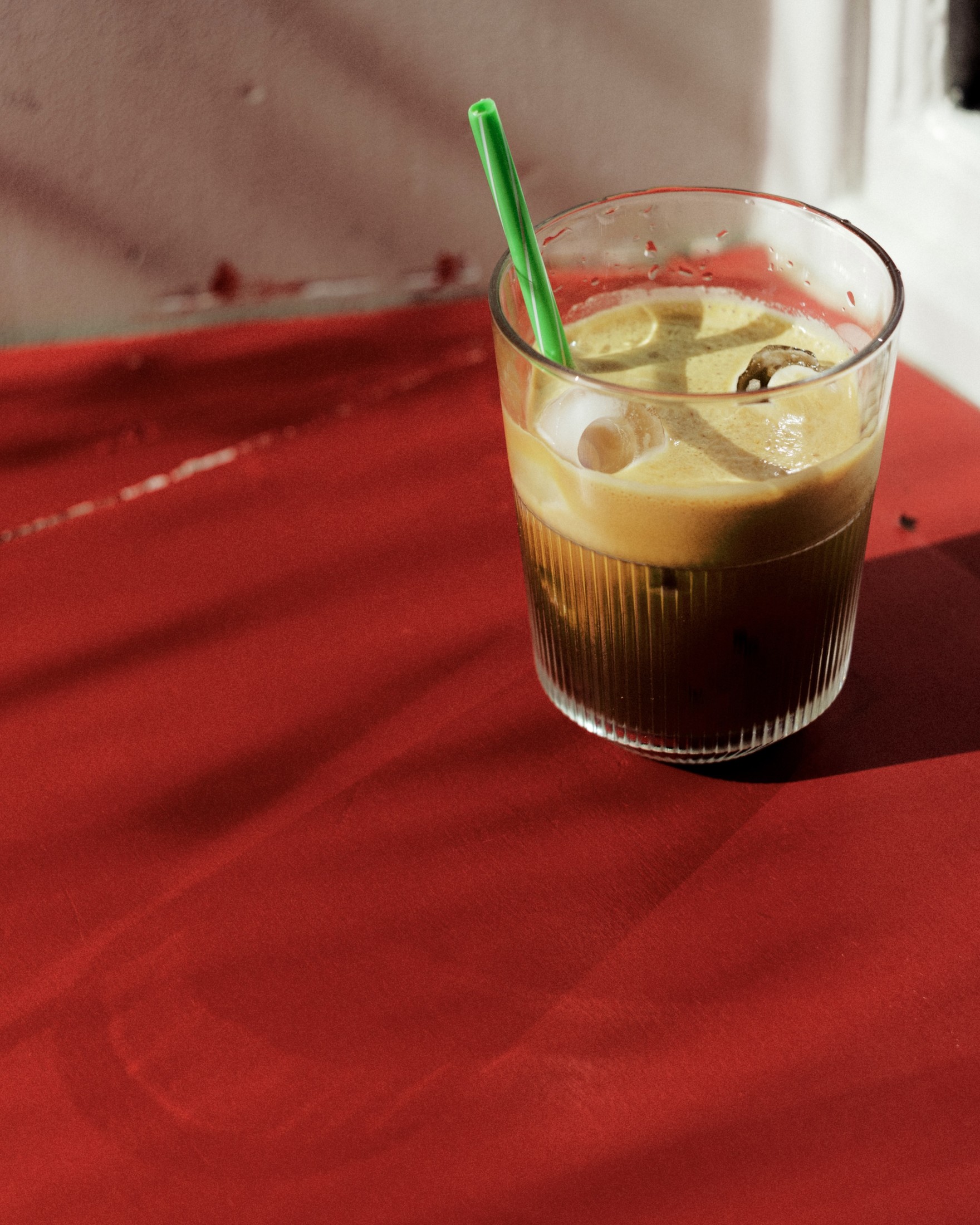 Iced coffee in a glass on a red tablecloth