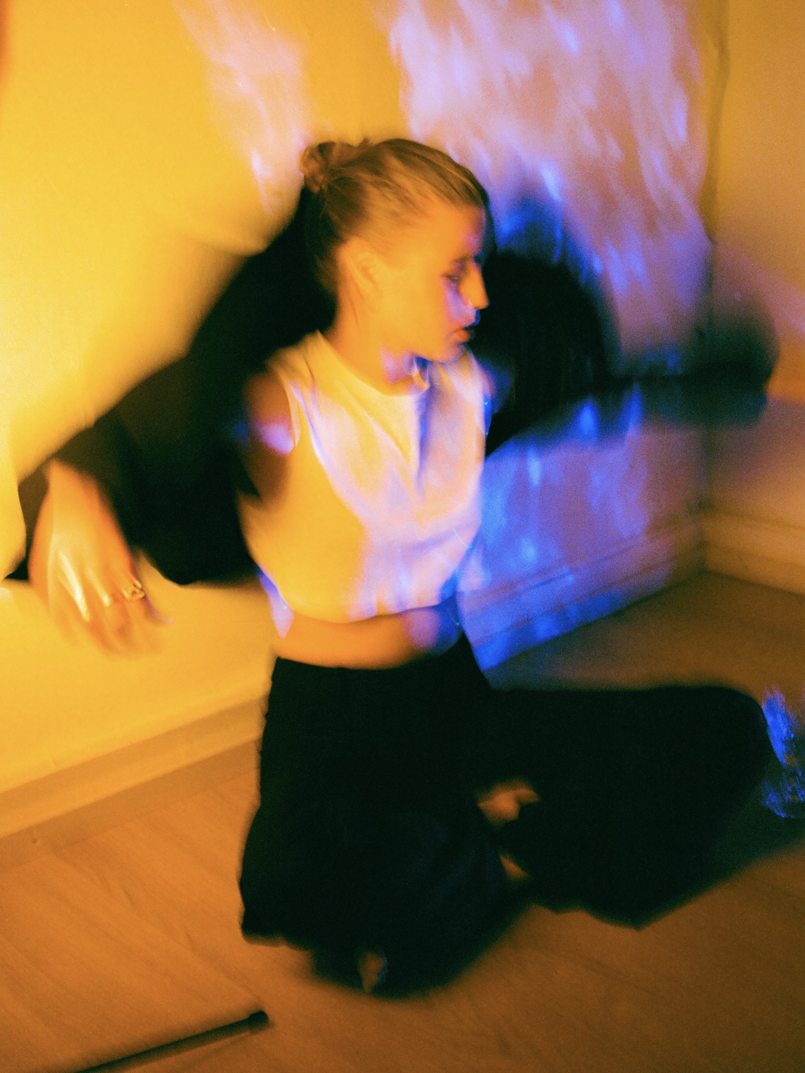 Colorful motion-blurred portrait of a figure dancing in warm and cool light