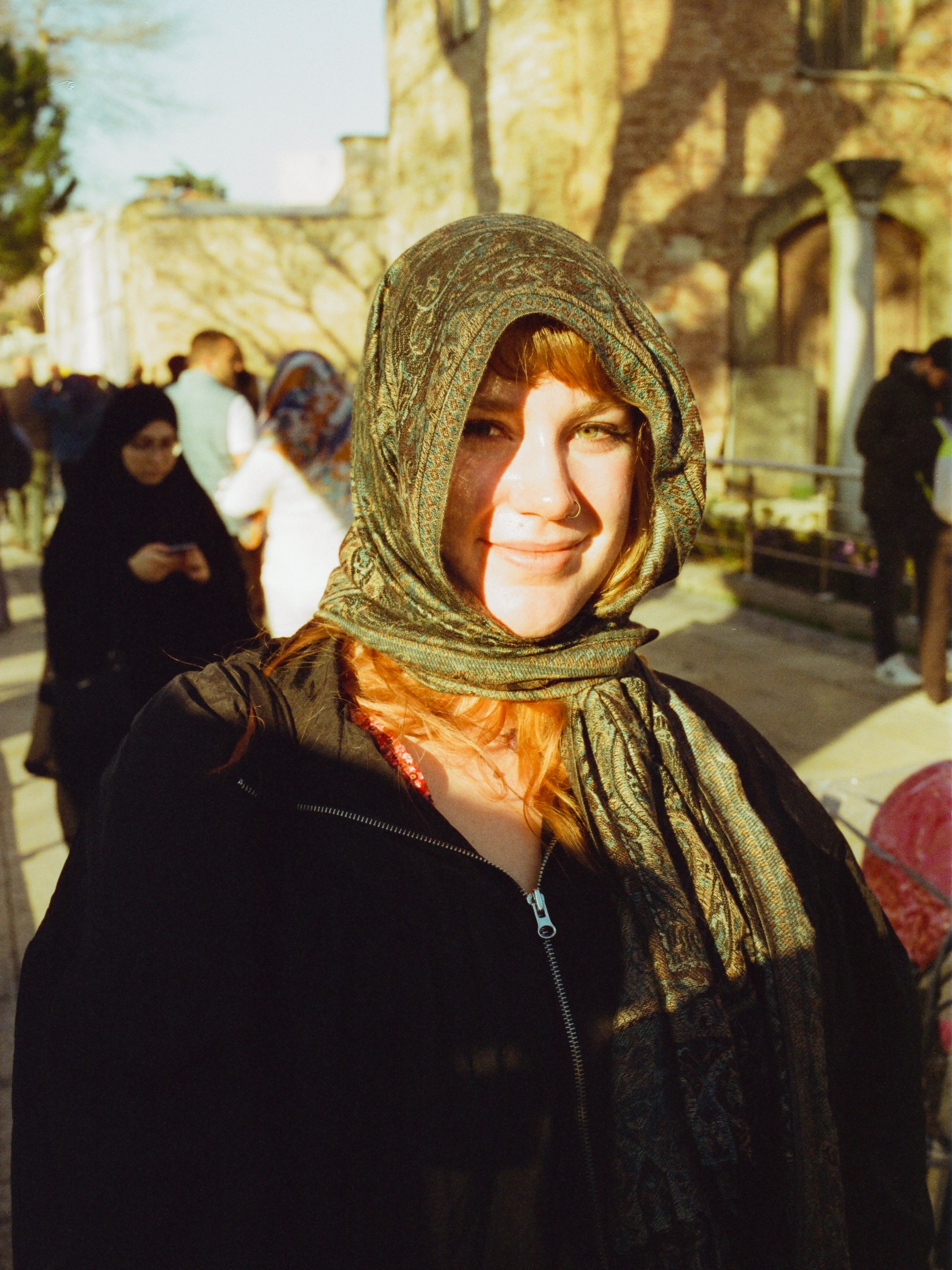 Warm street portrait of a woman in a headscarf