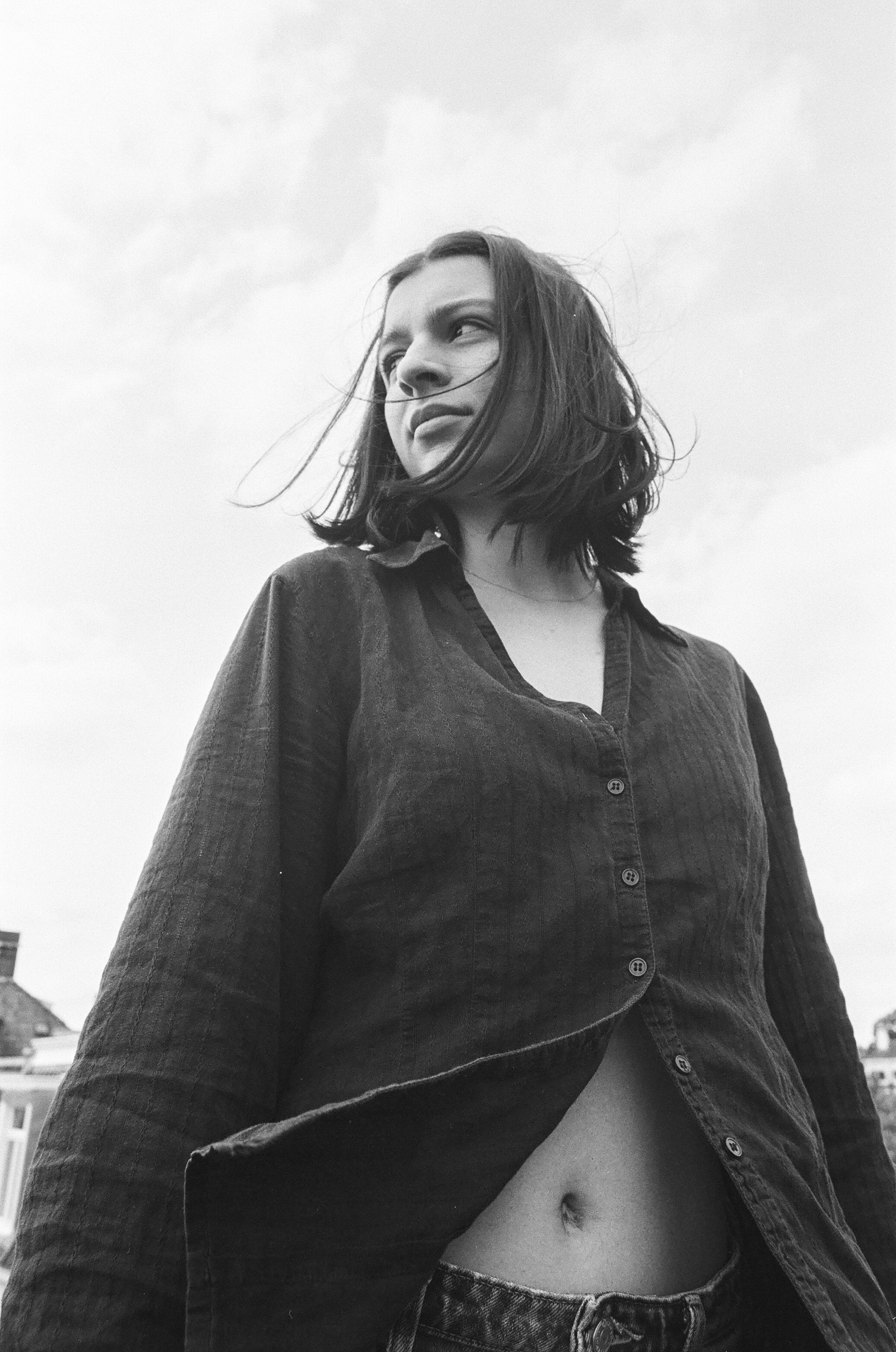 Black-and-white portrait of a woman in a cardigan lit by window light