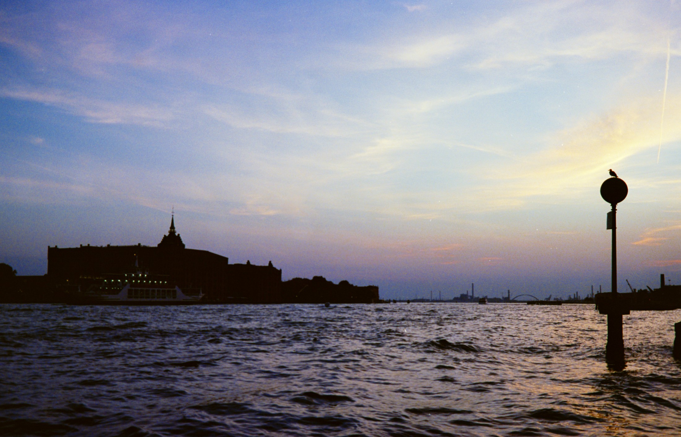 Sunset over the water with a fortress silhouette on a distant peninsula