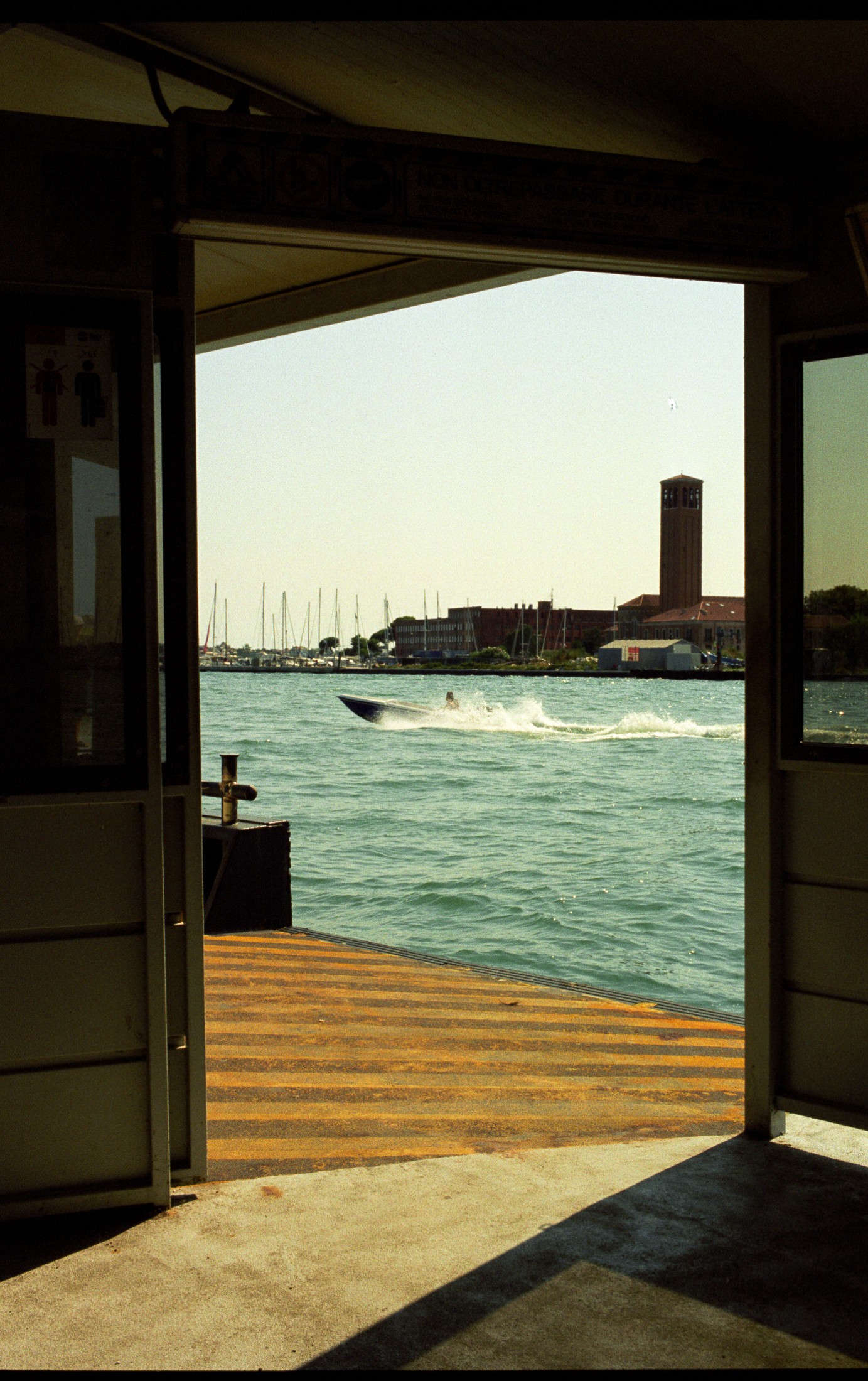 View through a doorway onto a harbor with boats