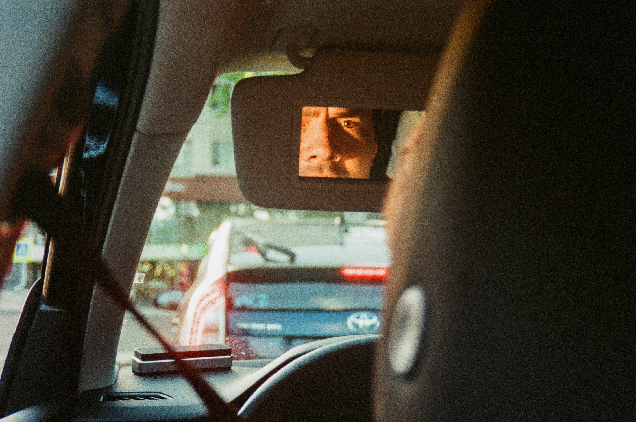 View through a car window of passing street reflections