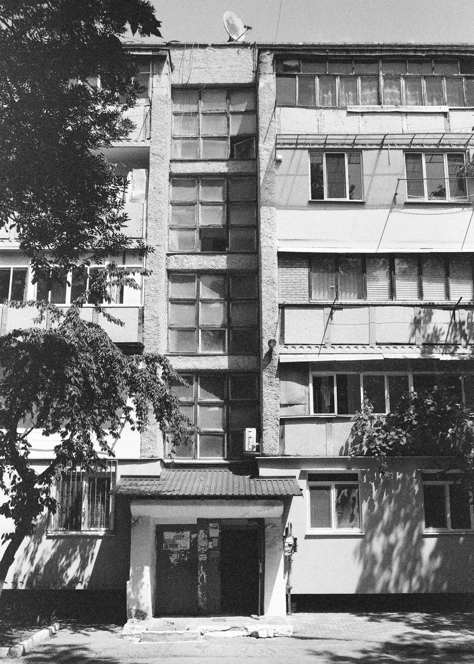 Black-and-white shot of an Eastern European apartment building facade